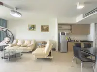 1 Bedroom Condo for Sale at Zire Wongamat open-plan living area with kitchen and seating
