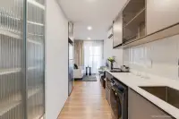 1 Bedroom Condo for Sale at Aquarous Jomtien Pattaya galley kitchen with glass-front cabinets opening to living and dining area