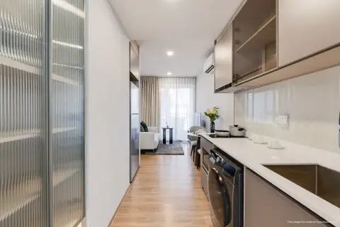 1 Bedroom Condo for Sale at Aquarous Jomtien Pattaya hallway view from kitchen towards living room with wood flooring