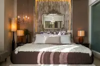 1 Bedroom Condo for Sale at Cetus Beachfront bedroom with king bed, ornate gilt mirror headboard and matching bedside lamps