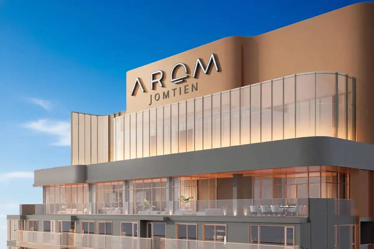 Arom Jomtien building exterior with 'Arom Jomtien' sign and upper-level balconies and terraces.