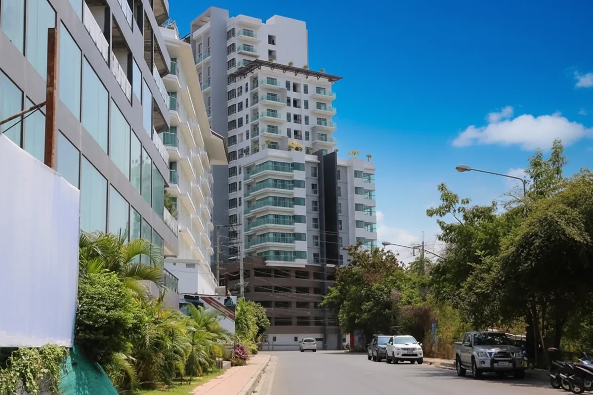 Axis Pattaya Condo aerial view of the rooftop pool area with surrounding city landscape and buildings.