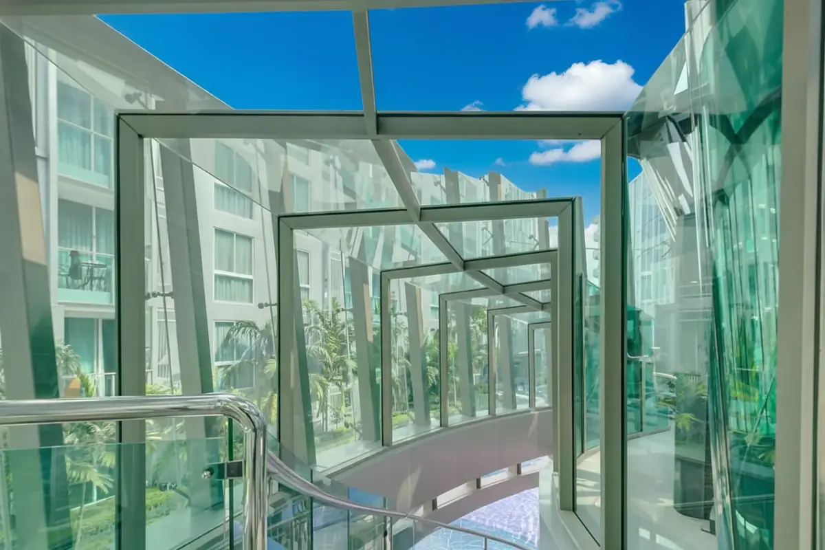 City Center Residence modern glass-enclosed walkway connecting buildings with views of the complex.