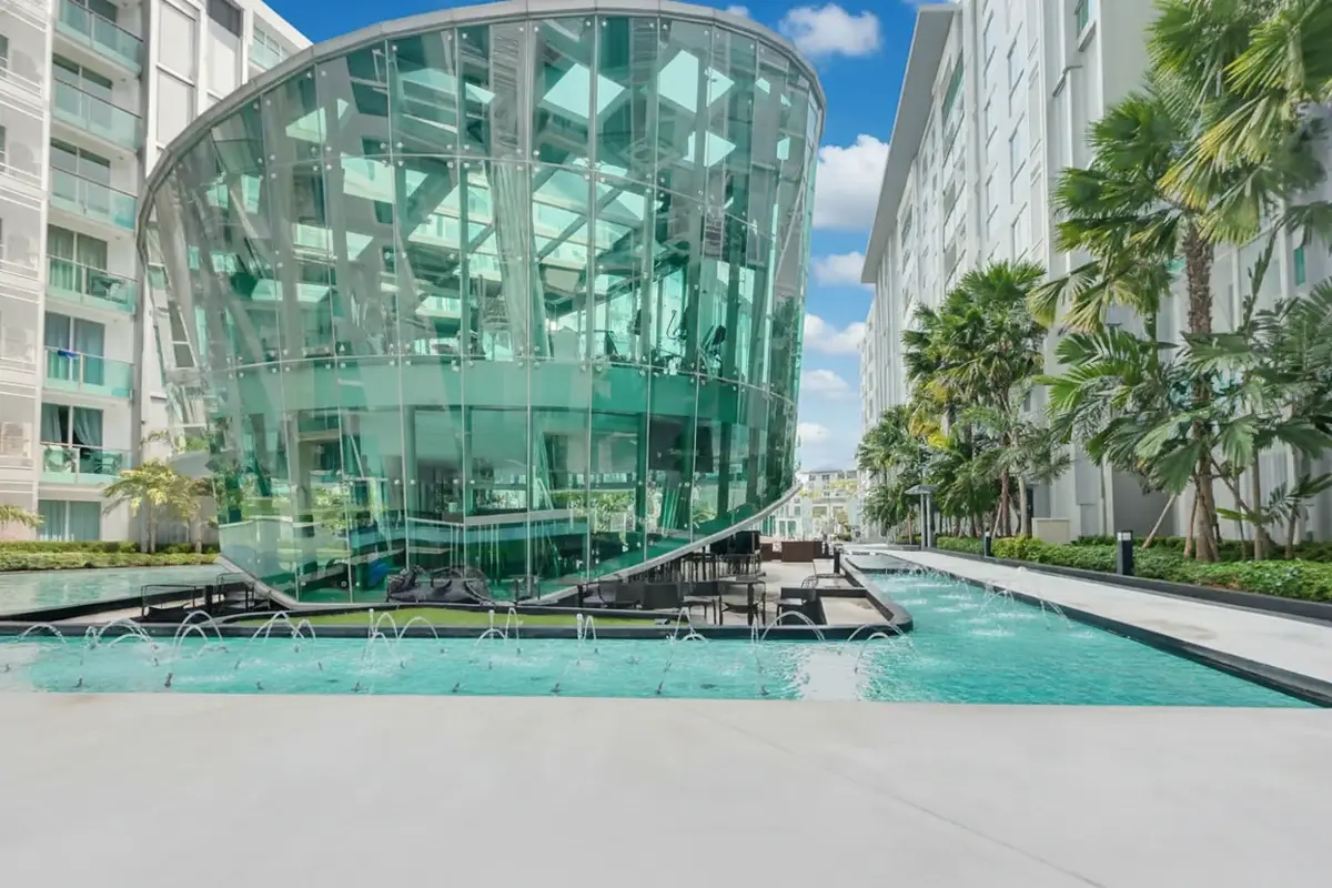 City Center Residence exterior view of a modern glass-domed building next to a decorative fountain.