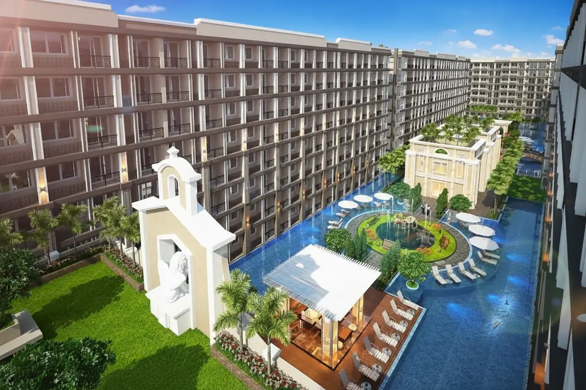 Dusit Grand Park 2 main building entrance at night, with illuminated Dusit Grand sign and water feature.