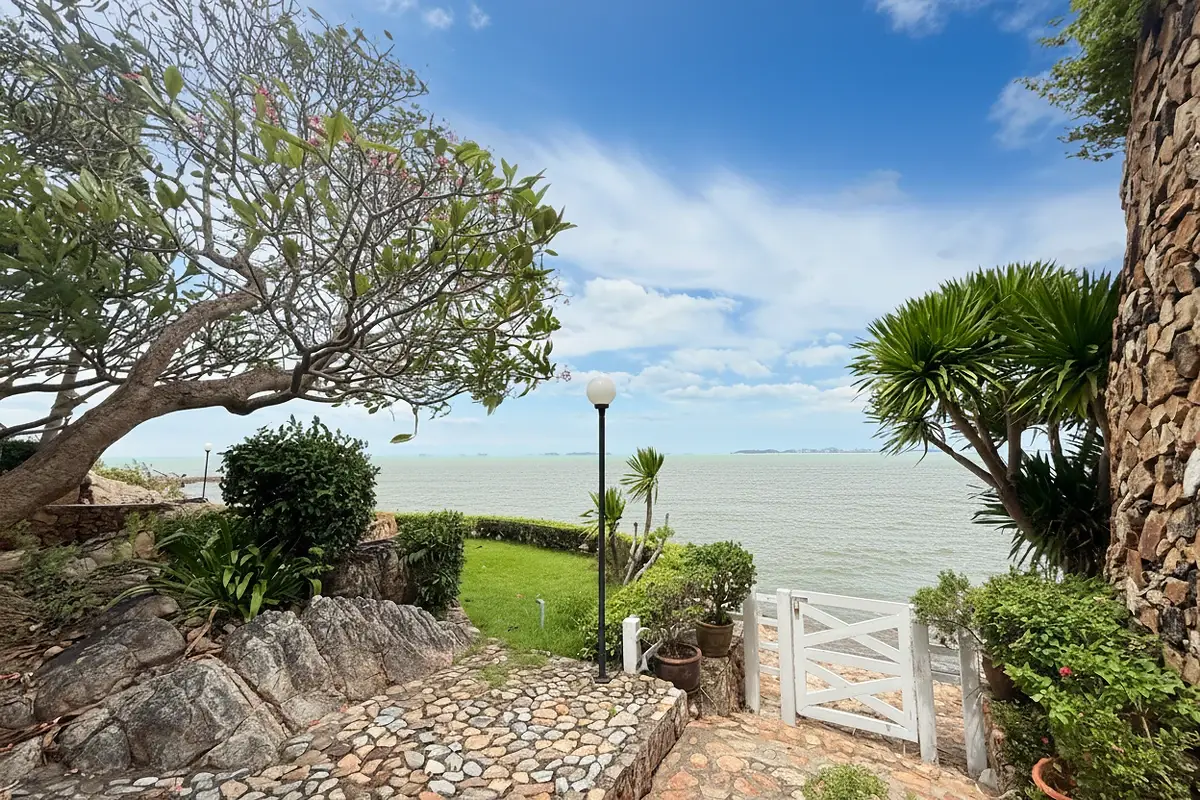 Garden Cliff Condominium 1 exterior view of the multi-story building with balconies and lush landscaping.