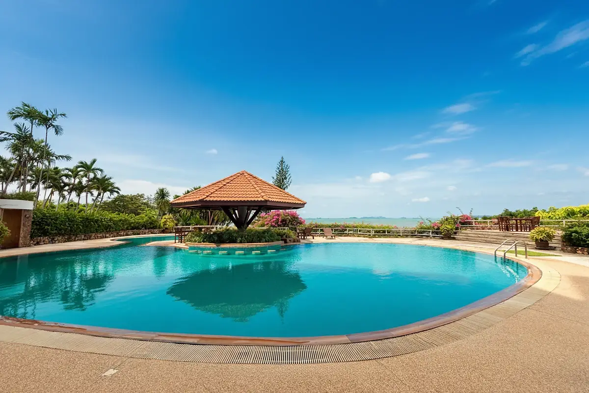 Garden Cliff Condominium 1 stunning panoramic ocean view from a cliffside with vibrant pink bougainvillea.