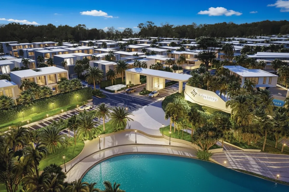 Glory Village Pattaya open-plan living area with high ceilings, white floors, and a kitchen island.