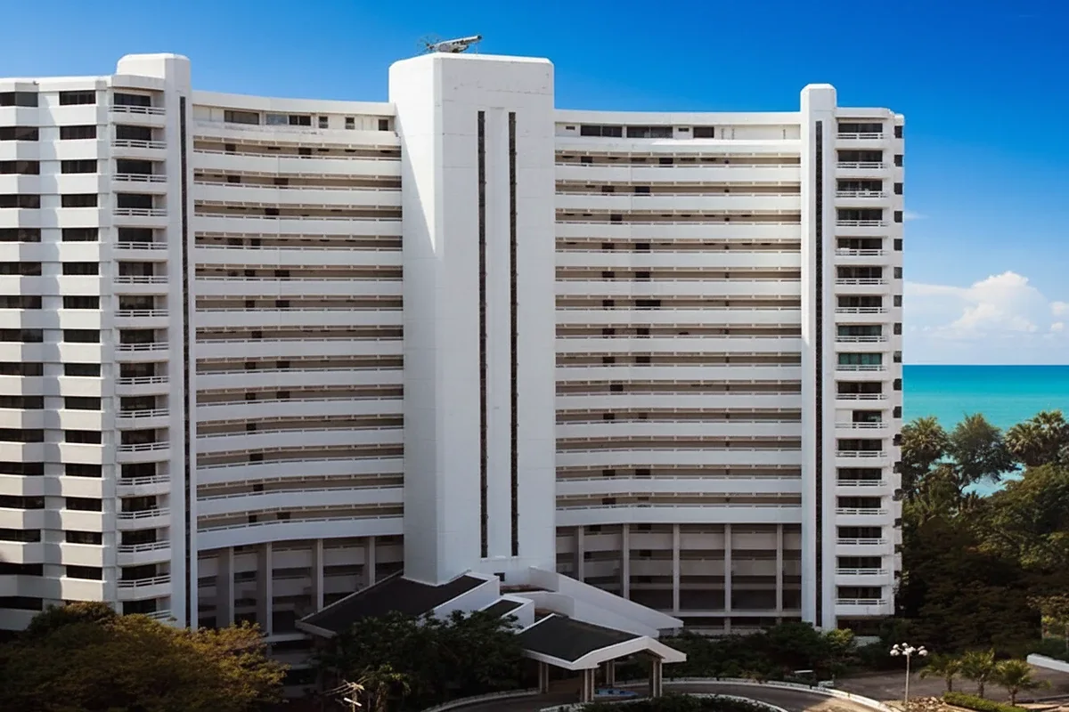 Grand Condotel exterior showing the tall white building from a low angle with a curved entrance.