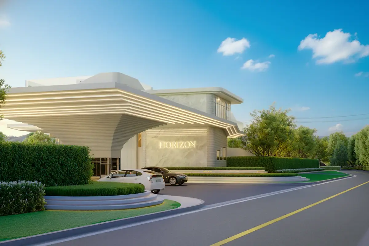 Horizon By Patta main entrance building with a modern design, cars, and lush green landscaping under a clear sky.