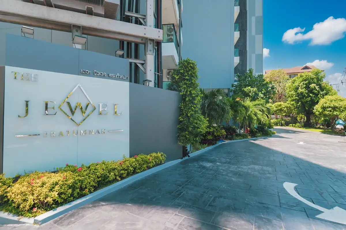 Jewel Pratumnak rooftop pool with city skyline and ocean views under a clear sky.