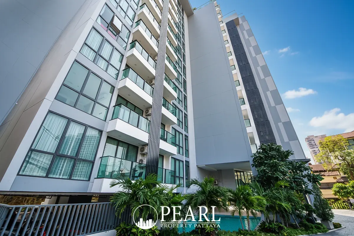 Jewel Pratumnak entrance sign for 'The Jewel Pratumnak' with lush landscaping and building exterior.