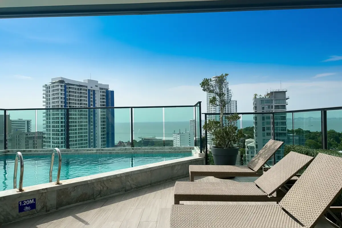 Jewel Pratumnak rooftop swimming pool with city and distant ocean views.
