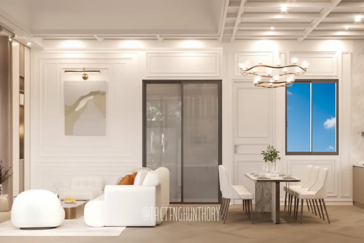 Larelana Villa living area with white sofa, modern chandelier, and dining table next to a glass sliding door.