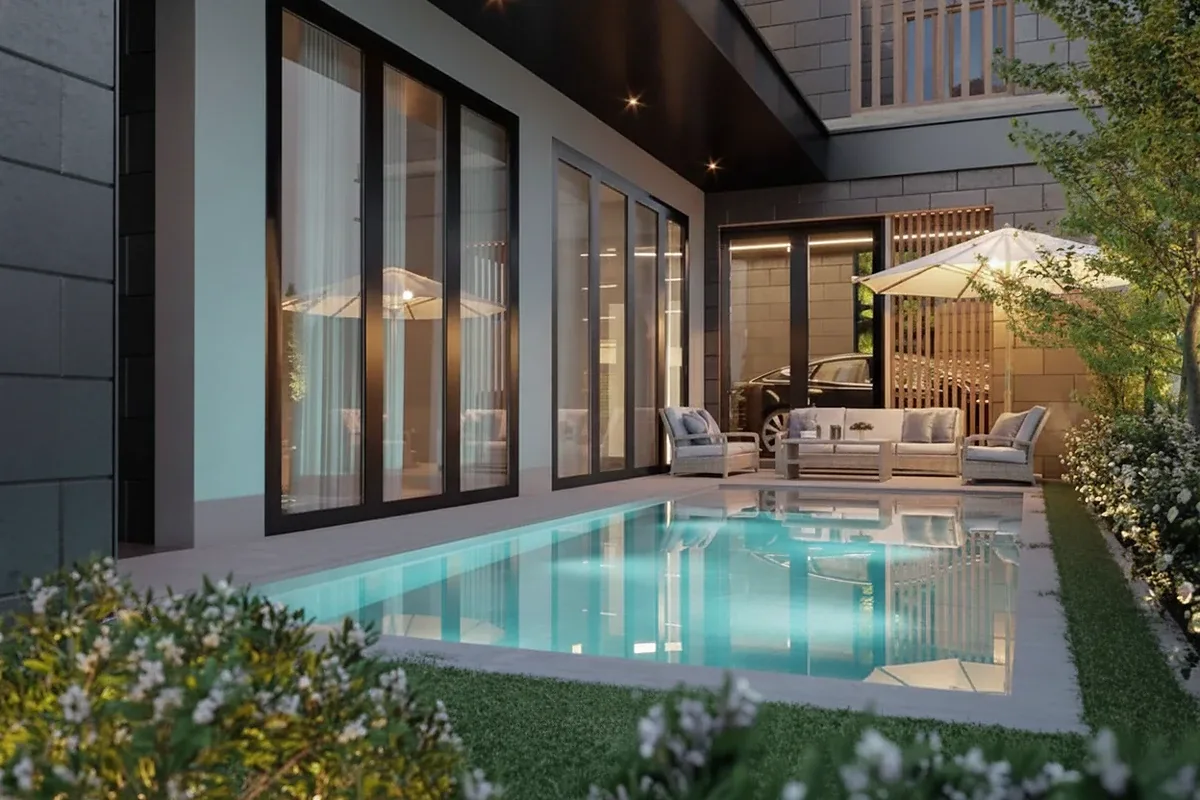 Madcha Le Villa modern house exterior with gabled roofs, large windows, and integrated two-car garage.