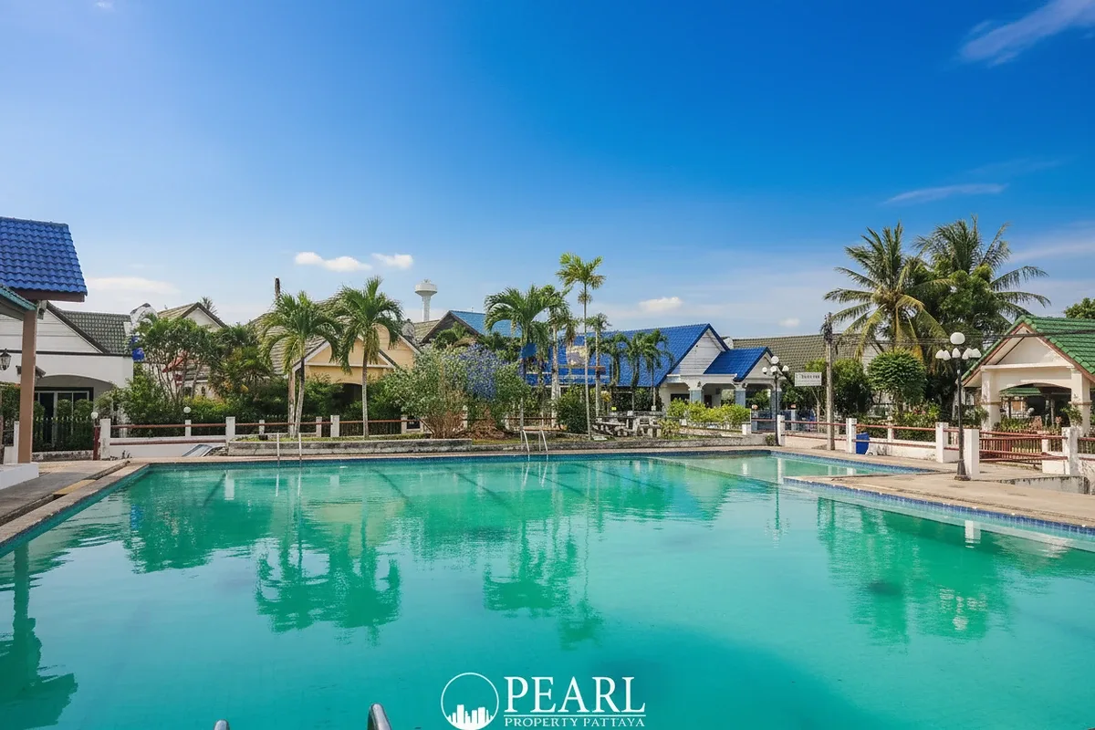 Natheekarn Park View residential street with houses, fences, parked cars, and dense overhead power lines.