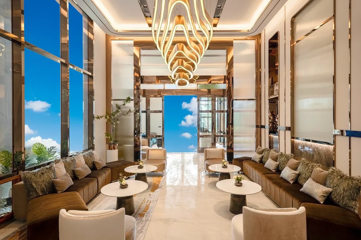 Once Pattaya luxurious lobby lounge area with stylish seating, marble floors, and a unique chandelier.