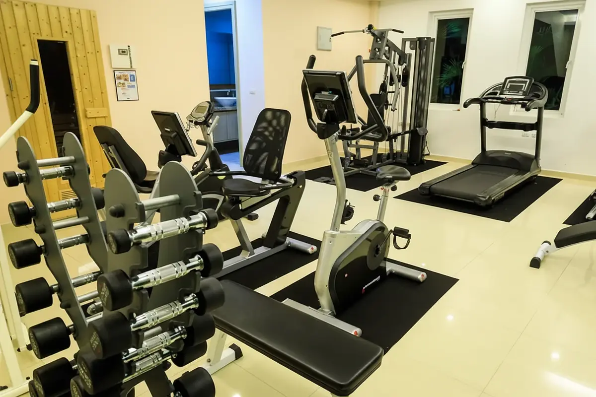 Paradise Ocean View: Well-equipped fitness center with treadmills, exercise bikes, and dumbbell rack.