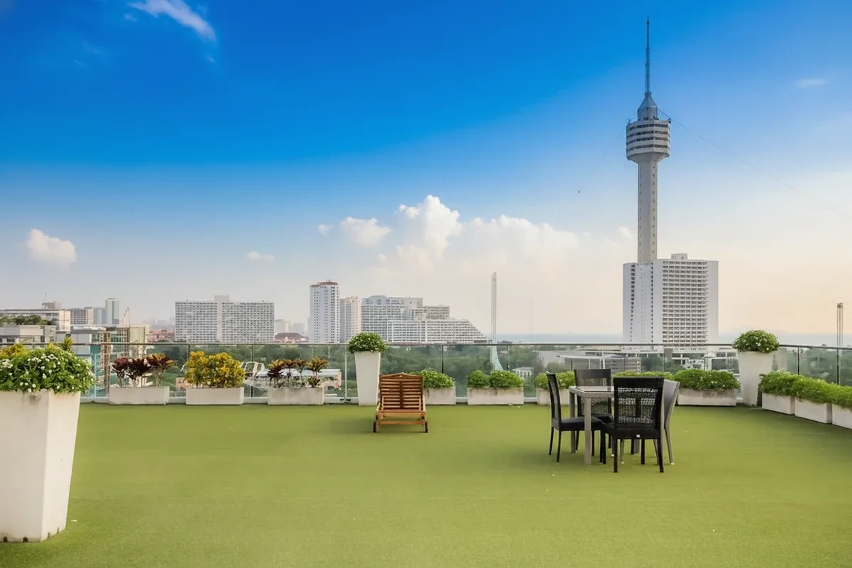 Park Royal 3 aerial view of the outdoor swimming pool area with sun loungers and palm trees between two buildings.