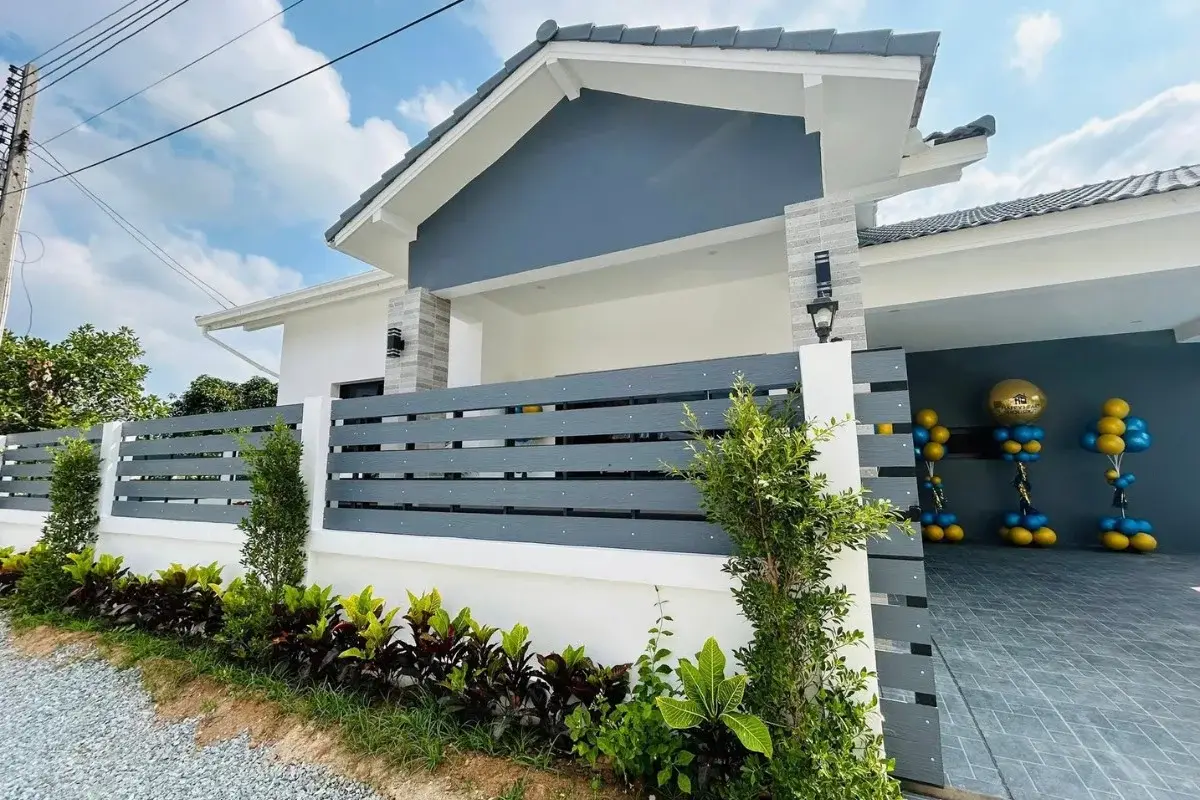 3 Bedroom House for Sale in Nong Prue front exterior with modern fence, landscaping, and driveway entrance.