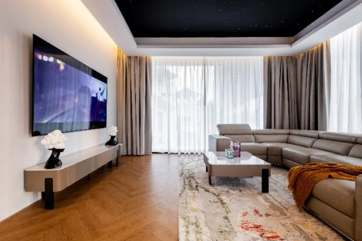 5 Bedroom House for Rent at Casa Jomtien: Living room with large TV, L-shaped sofa, and starry ceiling.