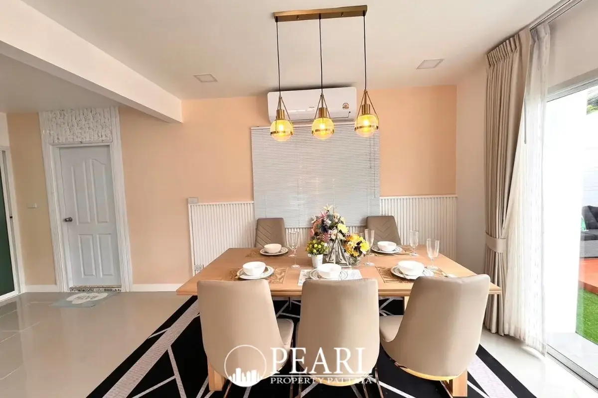 3 Bedroom House for Sale at Baan Pruksa Nara Chaiyapruek: dining area with wooden table, beige chairs, and modern pendant lights.