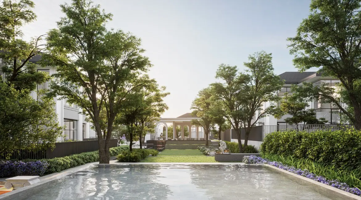 RAKHA PATTAYA beautiful green garden with a reflective pool, lush trees, and a distant gazebo.