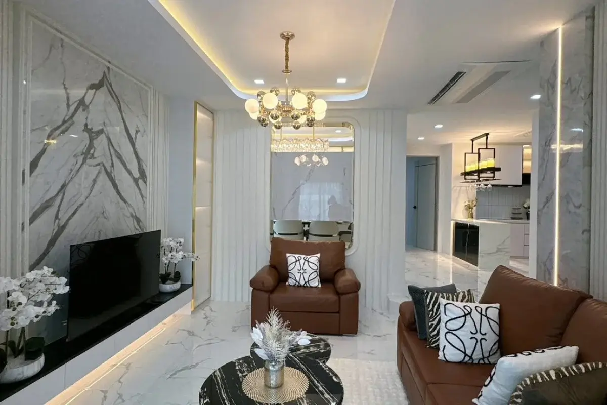 5 Bedroom House for Sale at Baan Suan Lalana, elegant living room with brown seating and view to dining area.