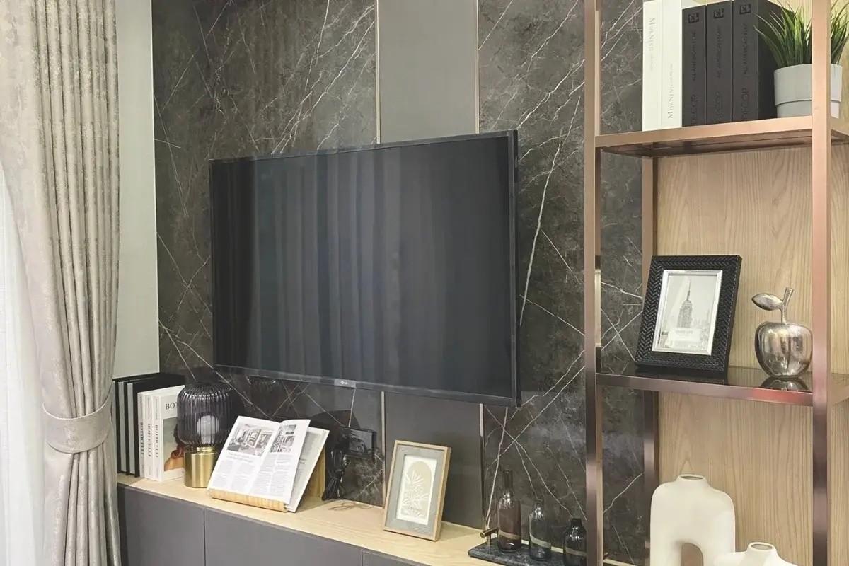 1 Bedroom Condo for Sale at Pristine Park 3, living room TV wall with dark marble pattern and decorative shelving.