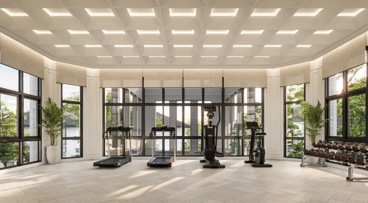 RAKHA PATTAYA spacious fitness room with treadmills, exercise machines, and large windows.