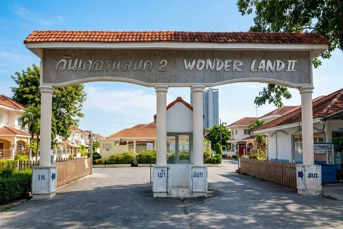 Wonderland II two-story house with a tiled roof, white facade, and ornate metal gate in Pattaya.