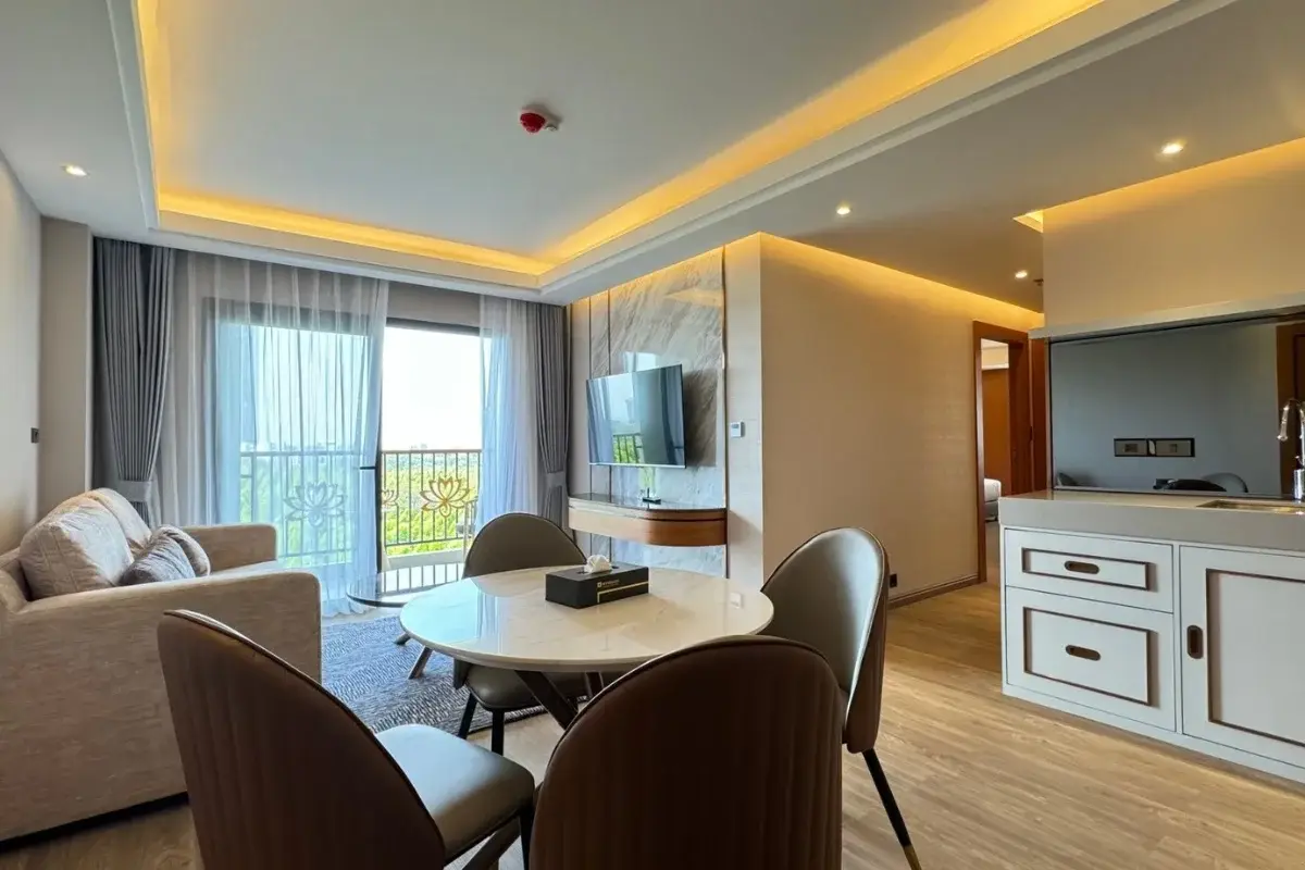 2 Bedroom Condo for Sale at Wyndham Jomtien Pattaya - open-plan living and dining area with balcony access.