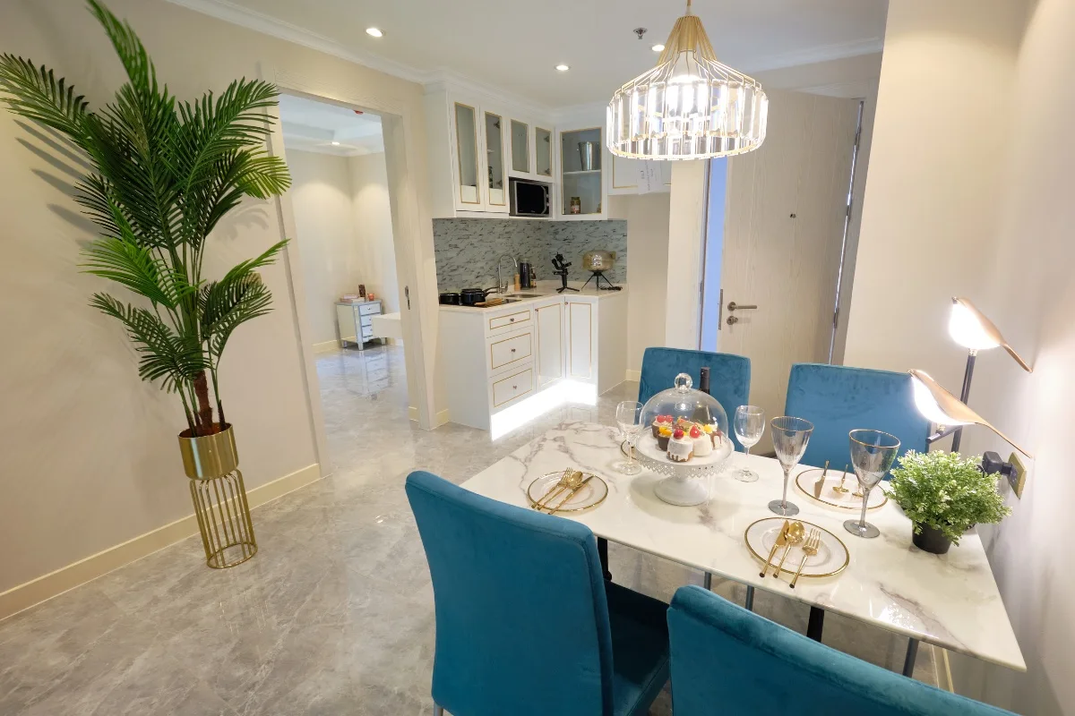 2 Bedroom Condo for Sale at Seven Seas Le Carnival white kitchen cabinets with gold trim and a built-in microwave.