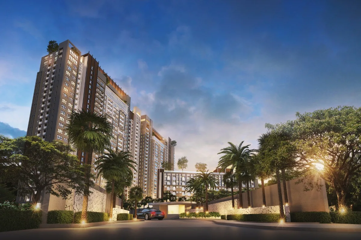Seven Seas Le Carnival grand entrance to the condo complex, with palm trees, illuminated landscaping, and a car arriving.