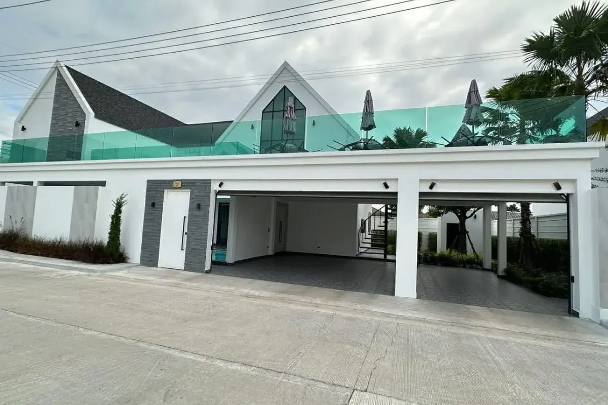3 Bedroom House for Sale at Larelana Villa front view with carport, modern architecture, and rooftop terrace.