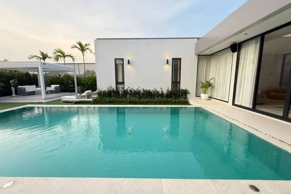 3 Bedroom House for Sale & Rent at The Prospect: Swimming pool with turquoise water, surrounded by modern white walls and lush greenery.