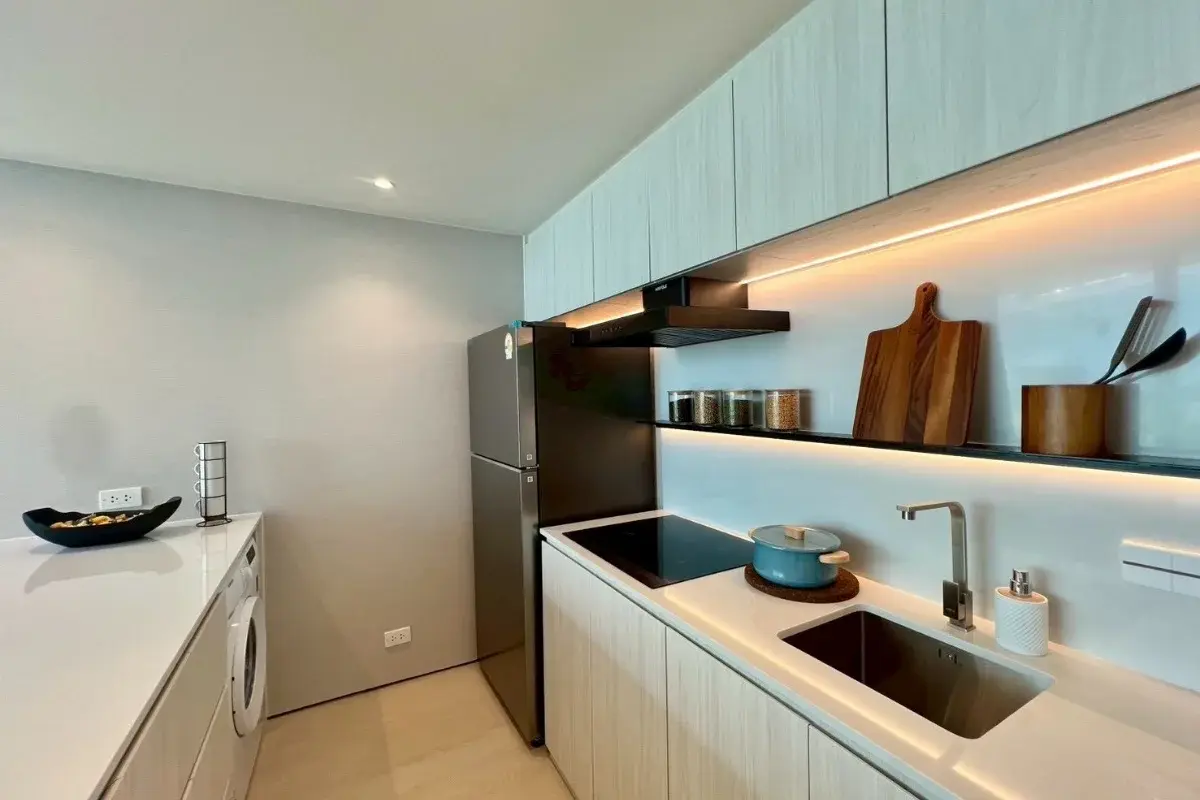 2 Bedroom Condo for Sale at Celine Wongamat kitchen with built-in appliances, sink, cooktop, and under-cabinet lighting.