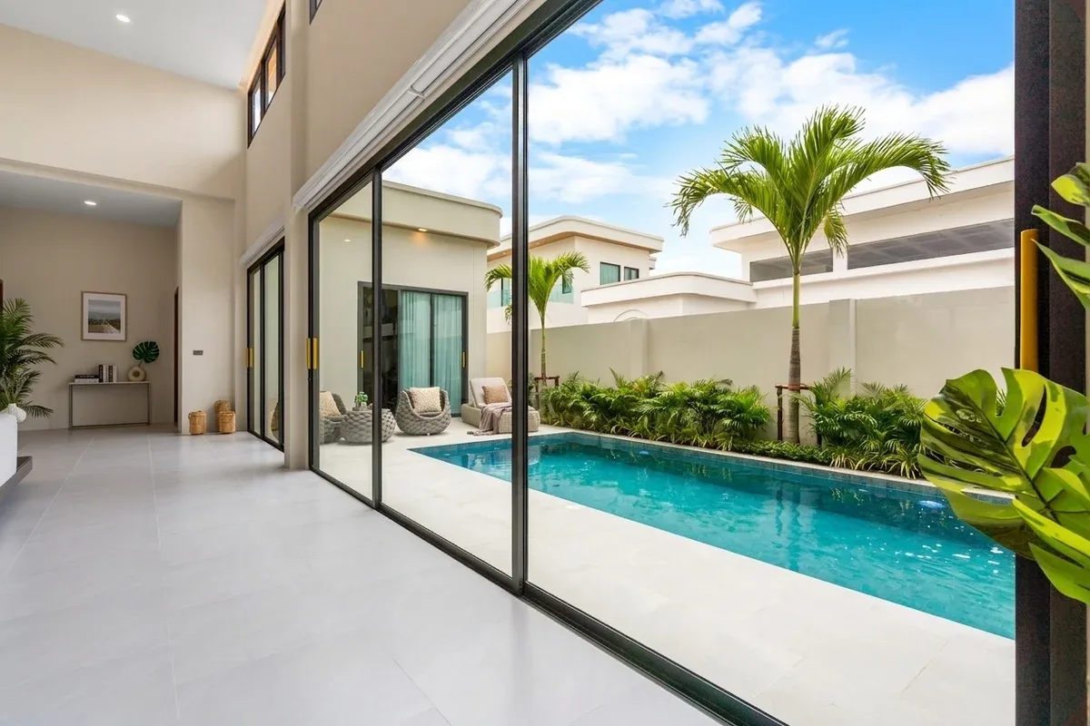 3 Bedroom House for Sale at Perla Villa, luxurious open-plan living room and kitchen with marble accents and dining area.