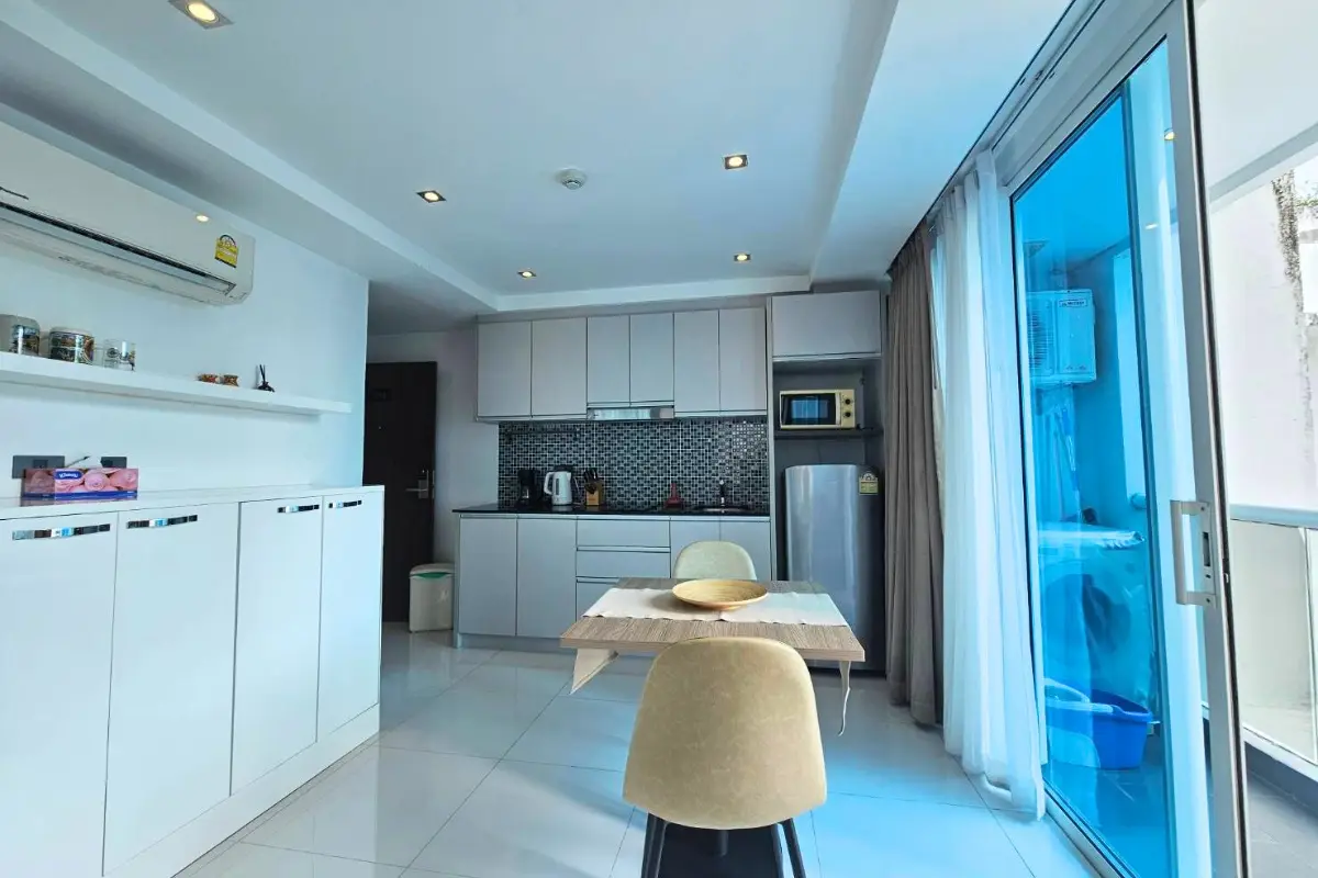 1 Bedroom Condo for Sale & Rent at Serenity Wongamat with kitchen, dining area, and balcony access.