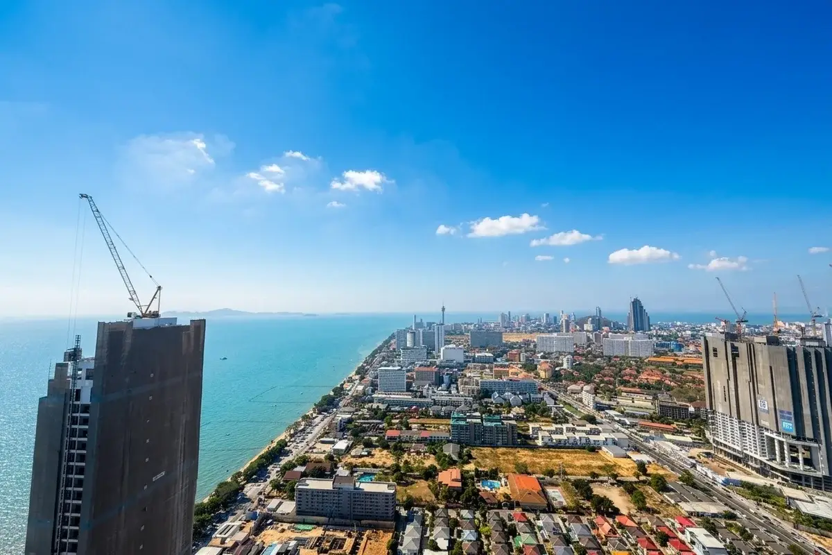 1 Bedroom Condo for Sale at Copacabana Beach Jomtien living and dining area with panoramic ocean and city views.