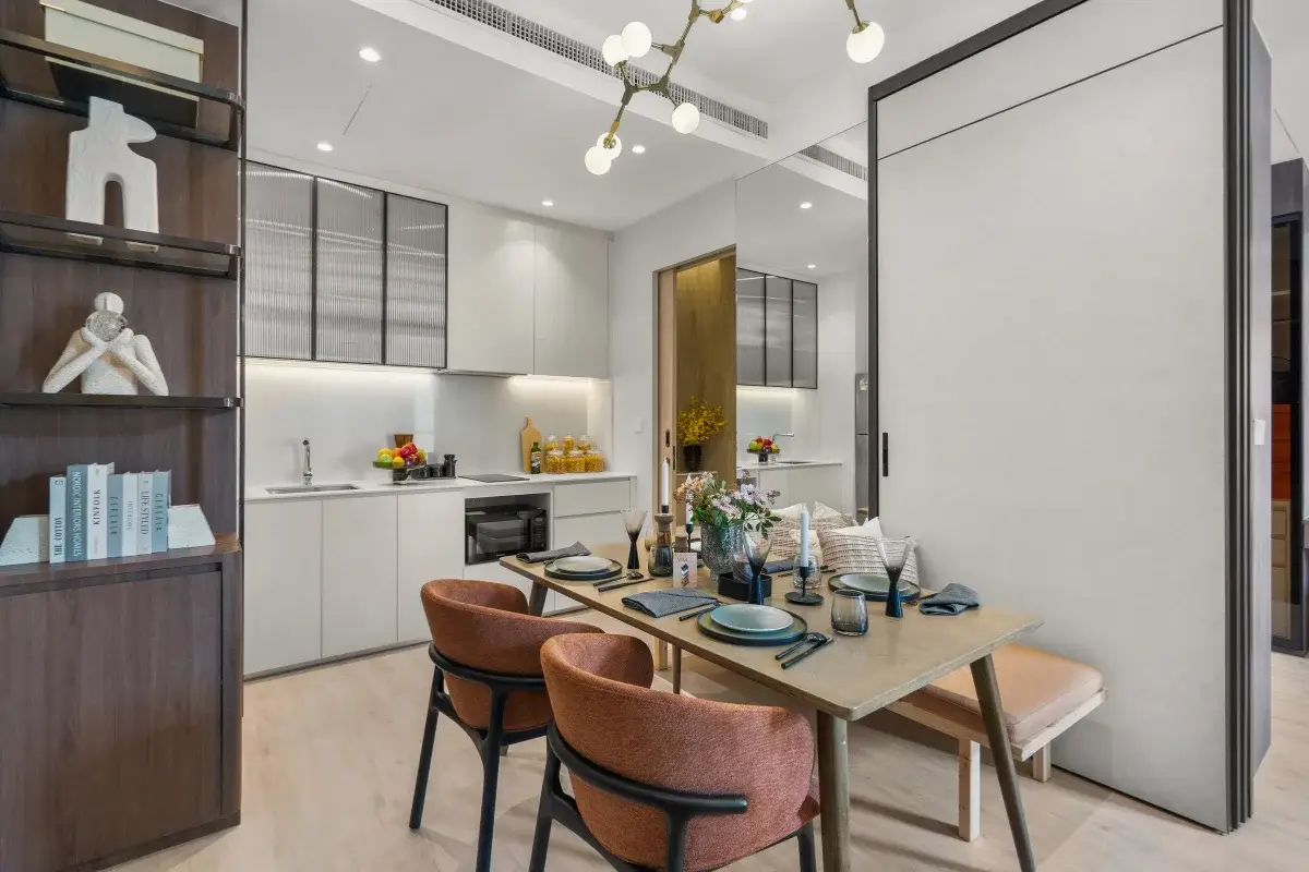 1 Bedroom Condo for Sale at Once Wong Amat: dining table set for four next to a modern kitchen with white cabinets.