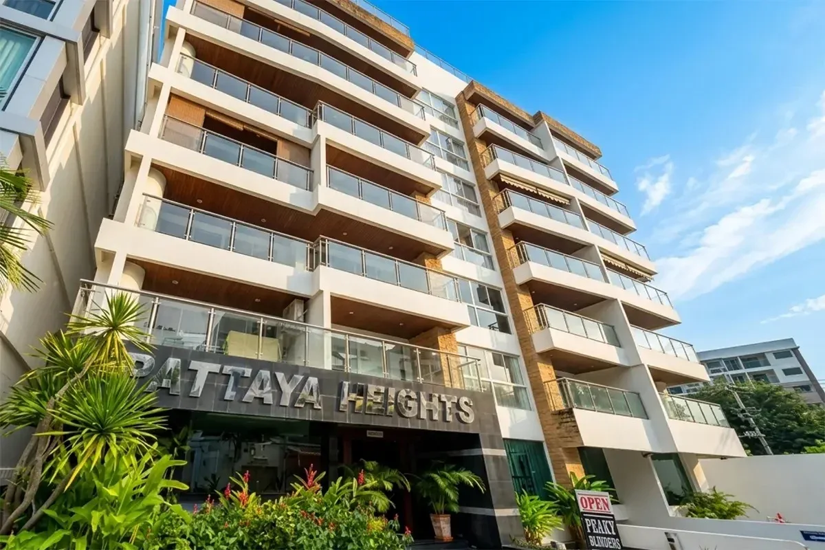 Pattaya Heights exterior view of the modern condo building with balconies, rooftop terrace, and surrounding city landscape.