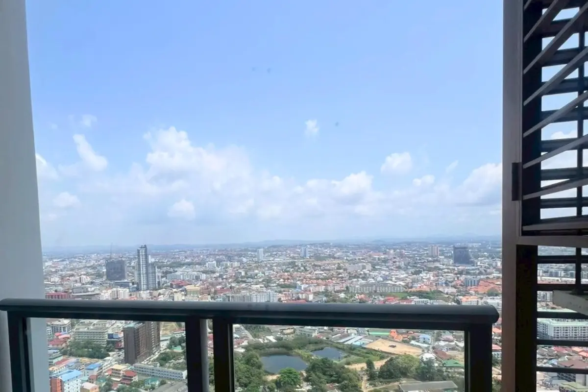 1 Bedroom Condo for Sale at Unixx South Pattaya: balcony view overlooking the city skyline and distant buildings.