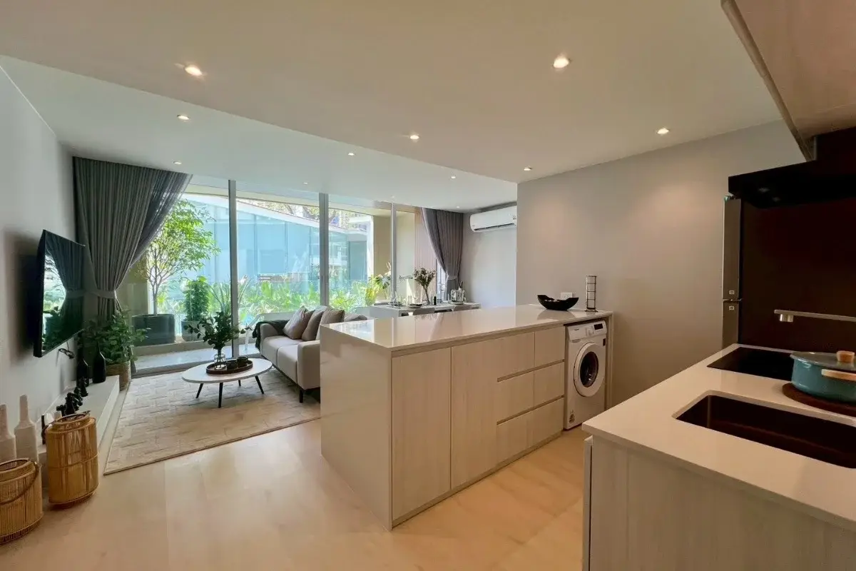 2 Bedroom Condo for Sale at Celine Wongamat modern kitchen with integrated washing machine, looking towards living area.
