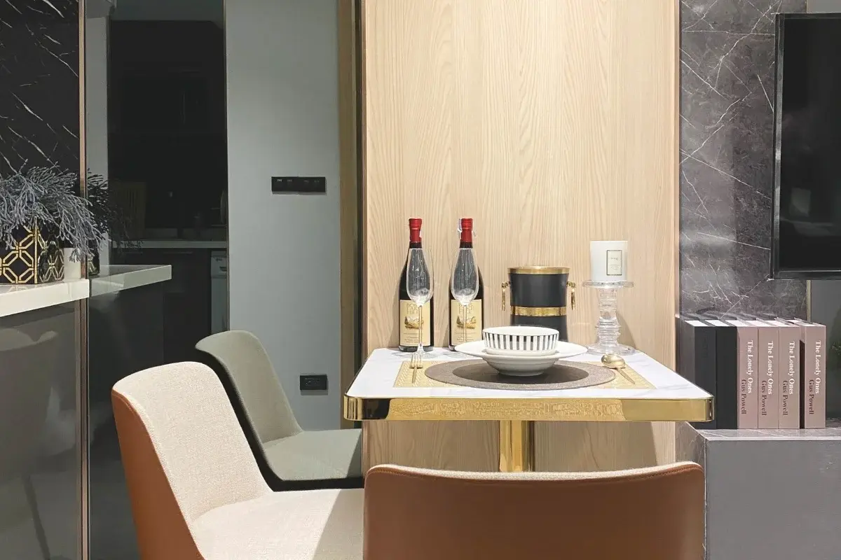 Studio Condo for Sale at Pristine Park 3 dining area with small table, two chairs, and wine bottles.