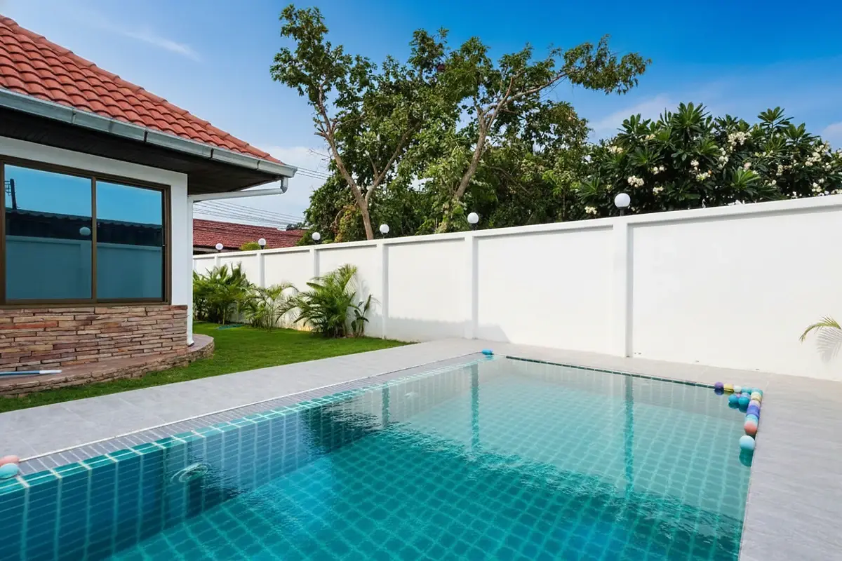 Royal View Village house exterior with a covered patio and green lawn.