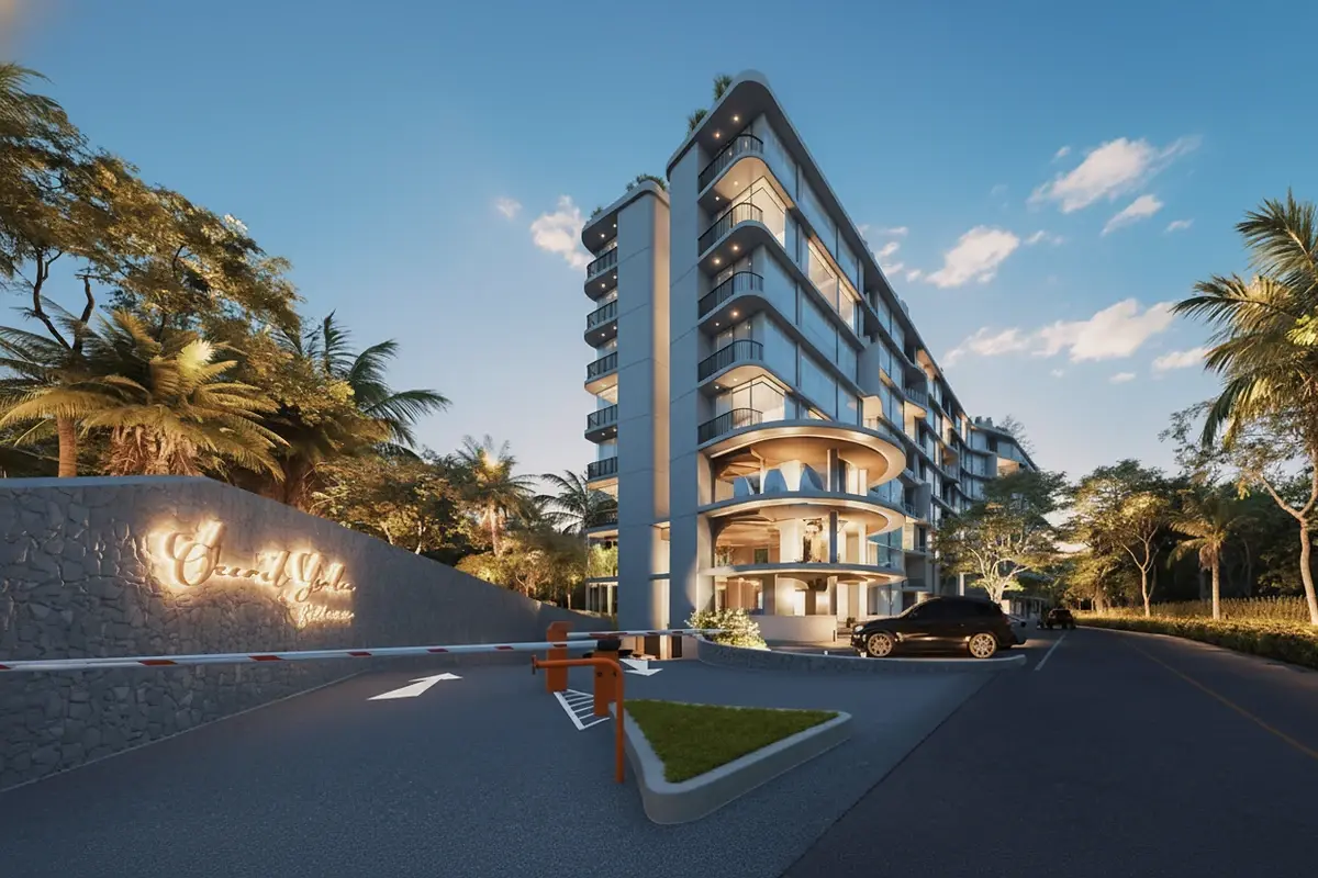 Secret Garden Condominium main entrance at dusk with security gate and illuminated sign.
