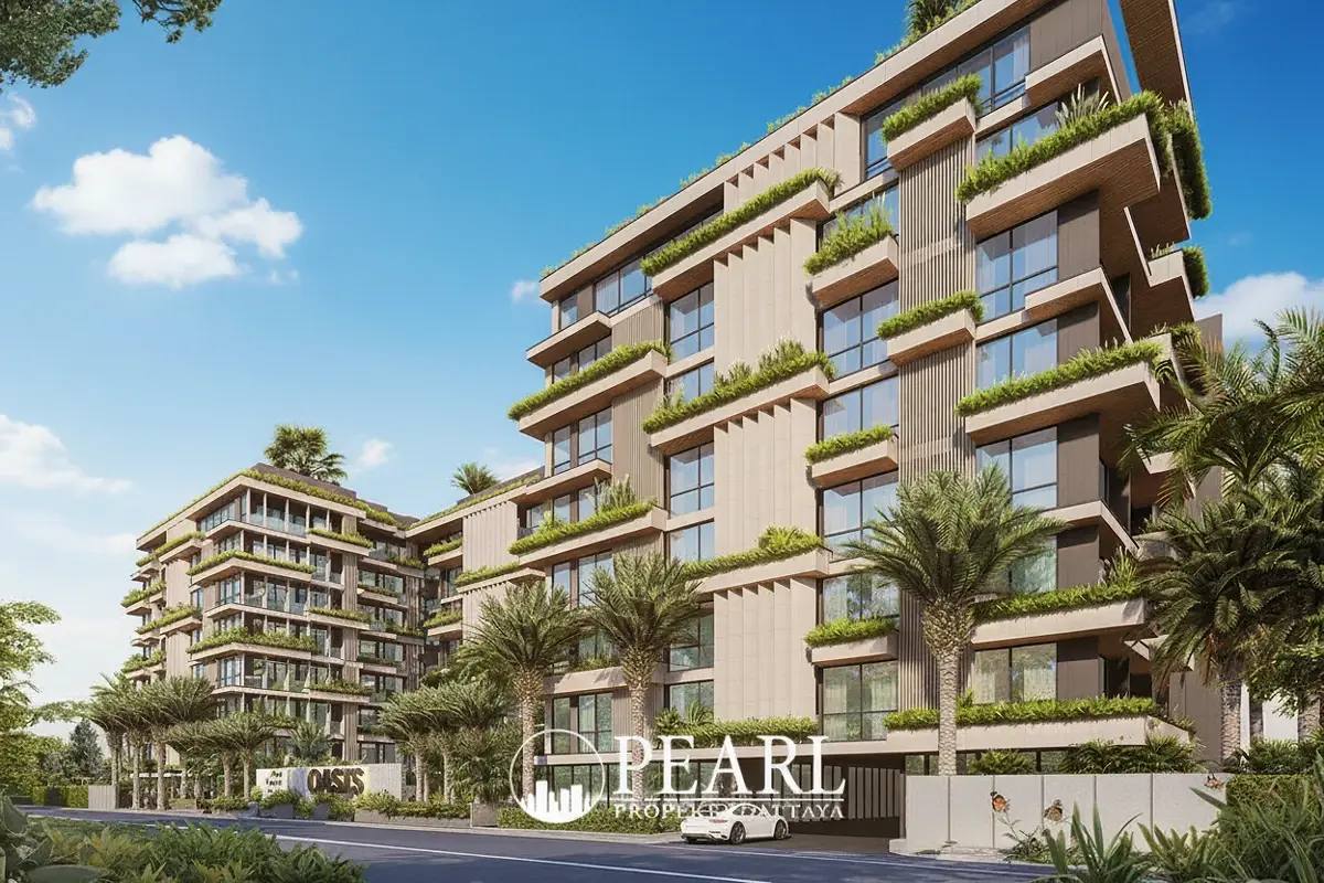 Siam Oriental Oasis modern building exterior with lush green balconies, palm trees, and a white car at the entrance.