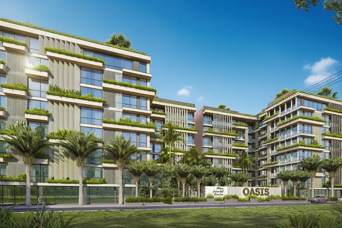 Siam Oriental Oasis modern condo buildings with extensive green landscaping, palm trees, and the property sign at the entrance.