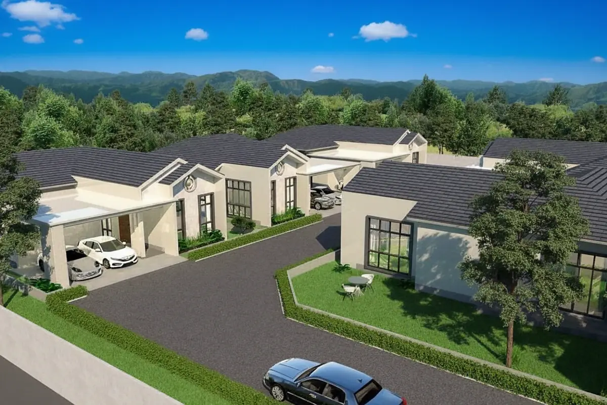 The Hamlet Pattaya, aerial view of multiple modern houses with carports, surrounded by lush green trees and mountains.